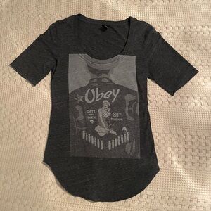 Women’s Obey shirt with Navy 89th division pin up girl graphic in dark grey.